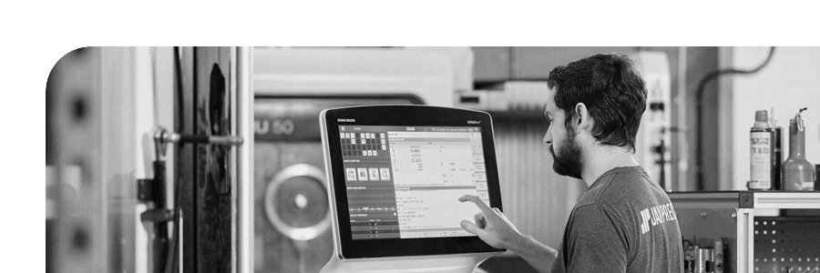 A machinist at a DMG Mori control on the shop floor